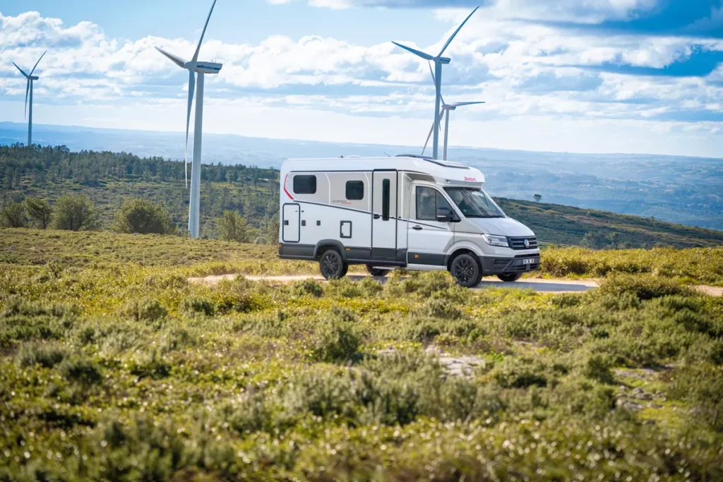 Dethleffs Globebus Teilintegrierter auf einer Straße mit Windrädern